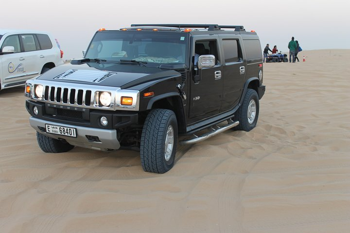 Experience the vastness of the Dubai desert aboard a private Hummer H2 conquering majestic sand dunes while surrounded by stunning landscapes and exceptional service—perfect for adventure seekers.